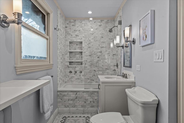 full bathroom with tiled shower / bath, vanity, and toilet