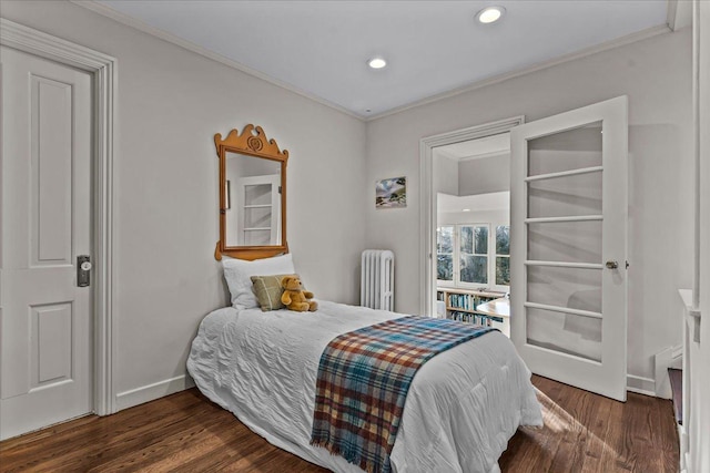 bedroom featuring dark wood-type flooring, crown molding, and radiator