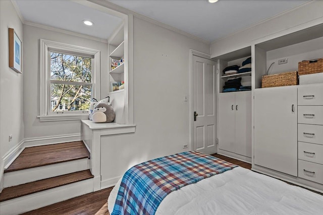 bedroom with crown molding and dark hardwood / wood-style floors