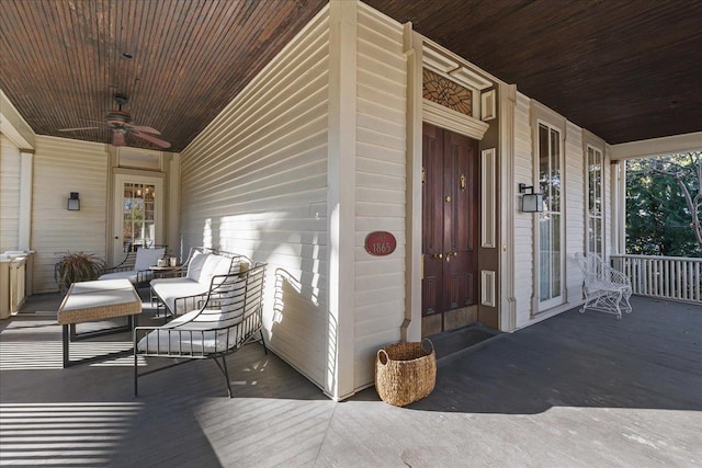 entrance to property featuring ceiling fan and a porch