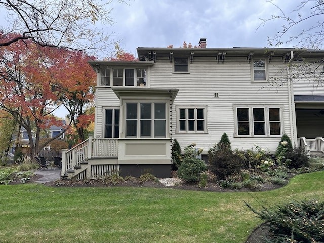 back of house with a lawn