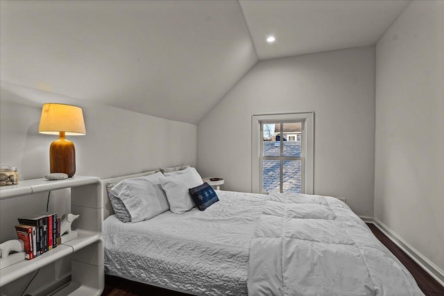 bedroom with dark wood-type flooring and vaulted ceiling