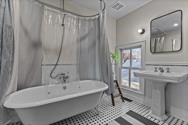 bathroom with shower / bath combination with curtain and tile walls