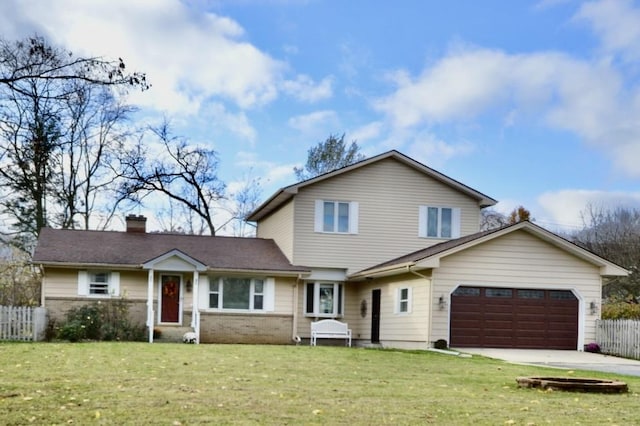 view of property featuring a garage and a front yard