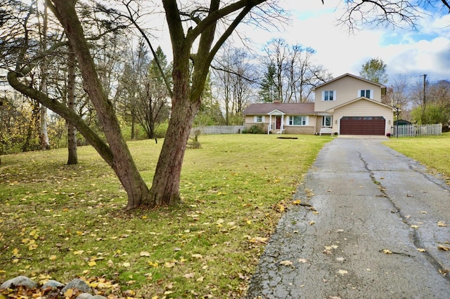 view of front of home featuring a front yard and a garage