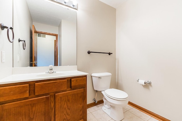 bathroom with tile patterned floors, vanity, and toilet