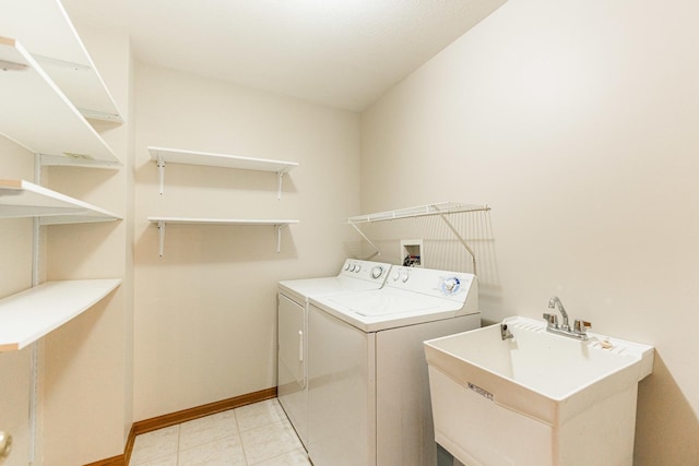 washroom with washer and clothes dryer and sink