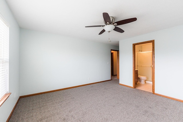 unfurnished bedroom with ceiling fan, light carpet, and ensuite bath