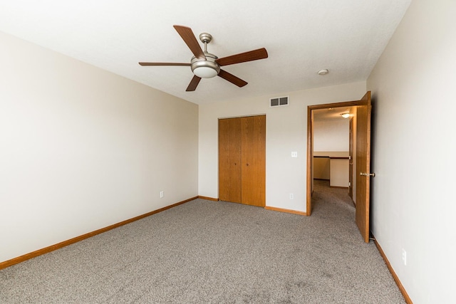 unfurnished bedroom with carpet floors, a closet, and ceiling fan