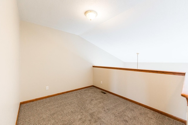 bonus room featuring carpet floors and vaulted ceiling