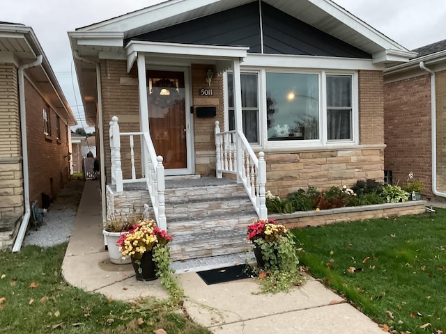 view of exterior entry with a lawn