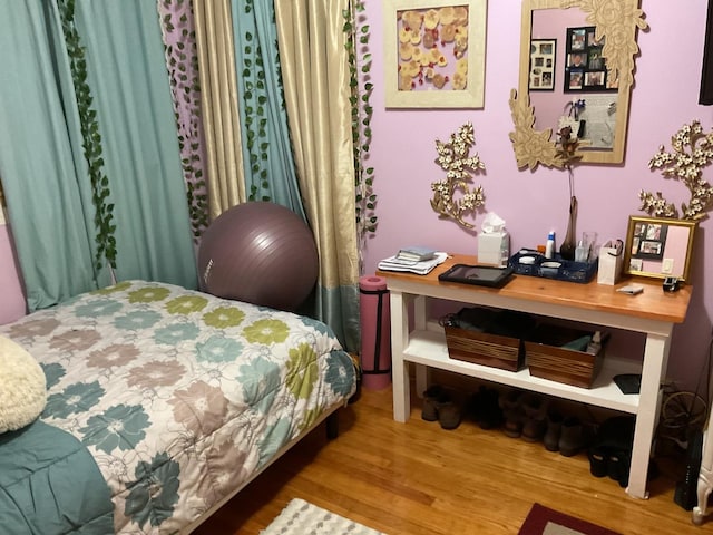 bedroom with hardwood / wood-style floors