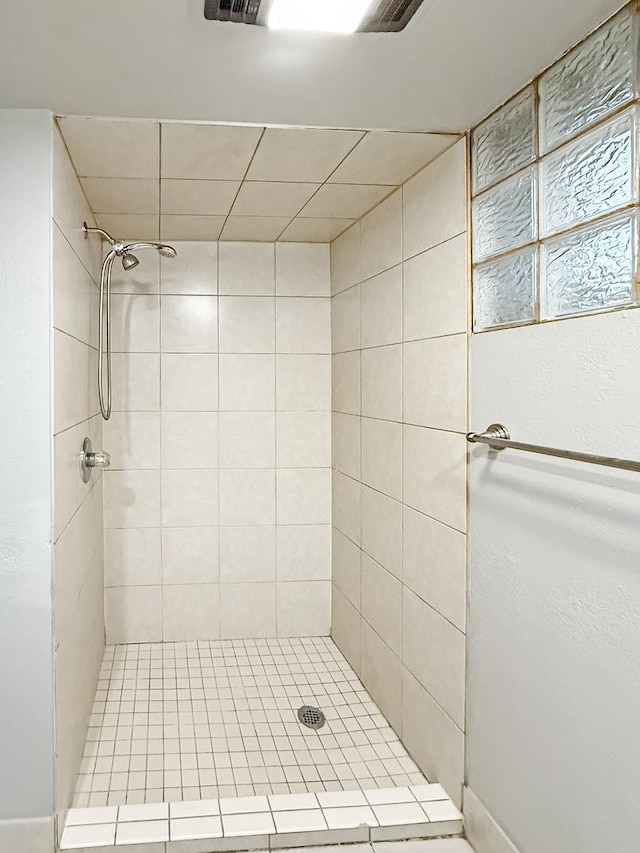 bathroom with tiled shower