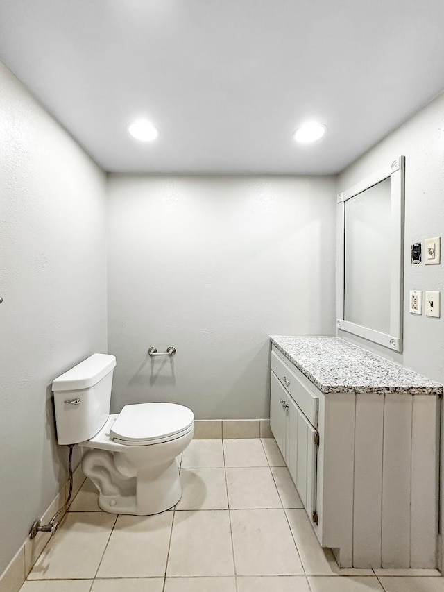 bathroom with tile patterned floors, vanity, and toilet