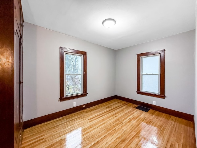 spare room with light hardwood / wood-style floors