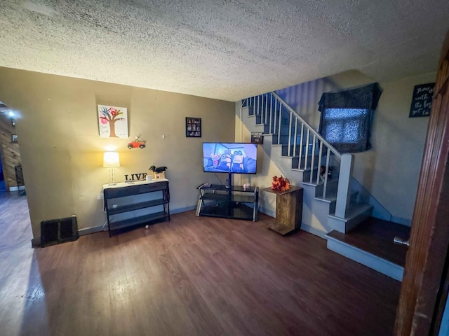 living room featuring hardwood / wood-style flooring and a textured ceiling