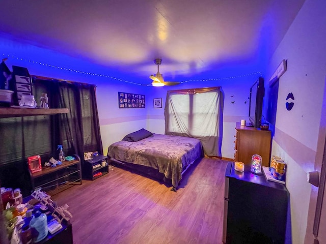 bedroom with hardwood / wood-style floors and ceiling fan