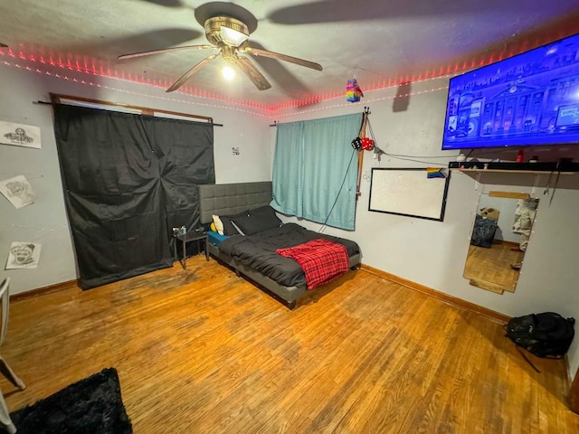 bedroom featuring ceiling fan and hardwood / wood-style flooring