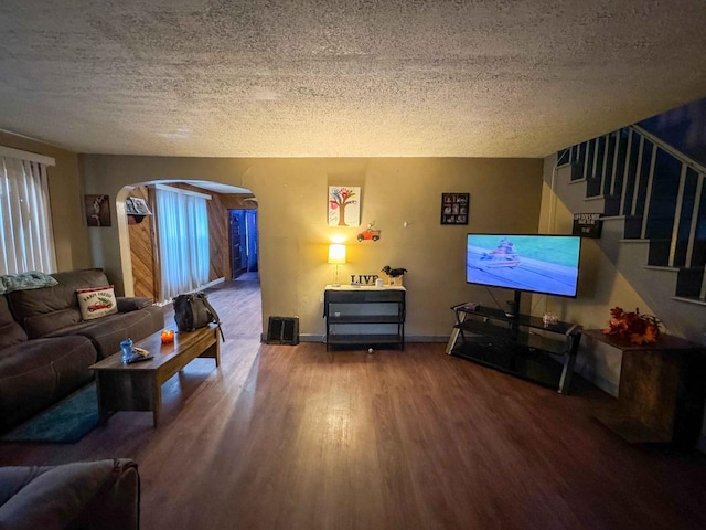 living room with hardwood / wood-style floors and a textured ceiling