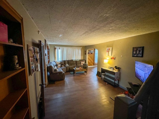 living room with hardwood / wood-style flooring and a textured ceiling