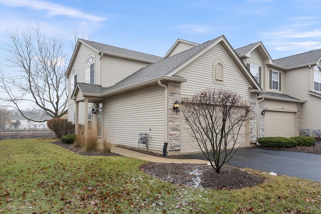 view of home's exterior featuring a garage and a lawn