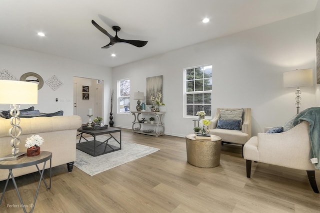 living room featuring ceiling fan and light hardwood / wood-style floors