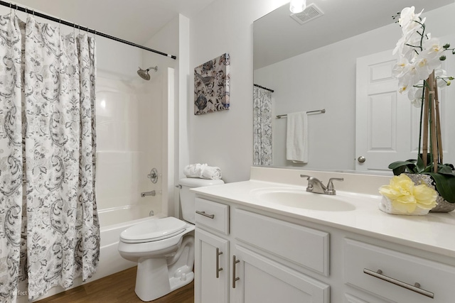 full bathroom featuring toilet, vanity, hardwood / wood-style flooring, and shower / tub combo with curtain