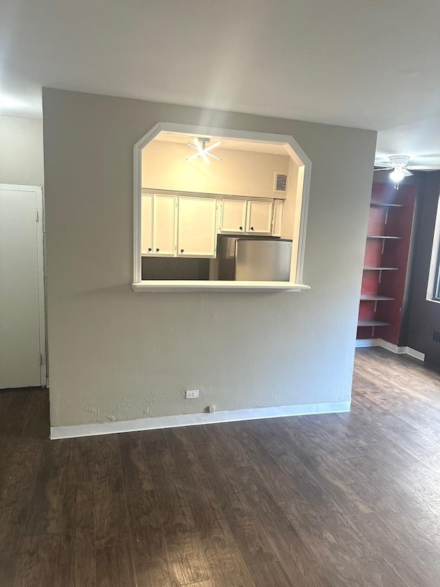 unfurnished living room with dark hardwood / wood-style flooring