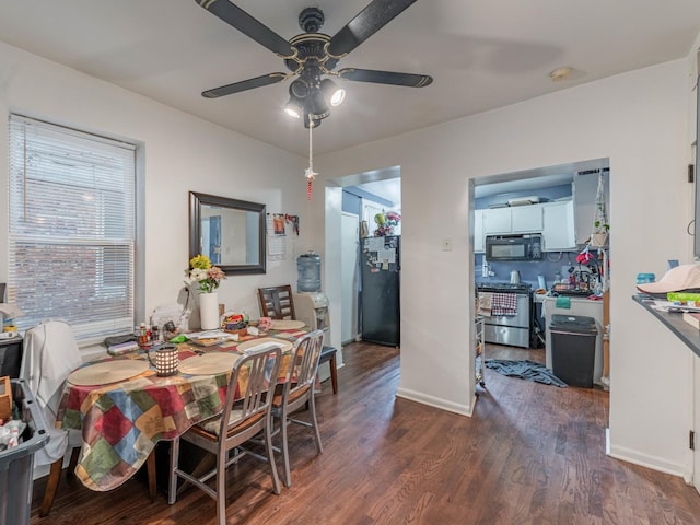 dining space with ceiling fan and dark hardwood / wood-style flooring