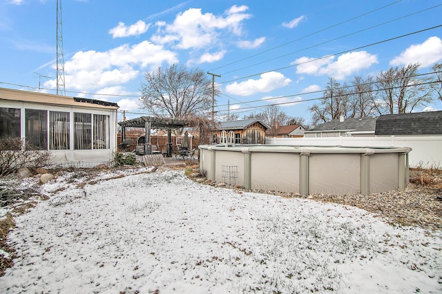 yard layered in snow featuring a pergola