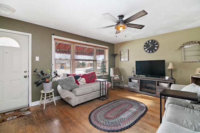 living room featuring hardwood / wood-style floors and ceiling fan