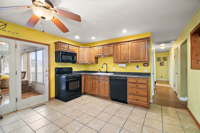 kitchen with light tile patterned floors, sink, ceiling fan, and black appliances