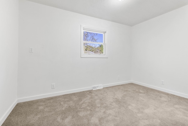 spare room with light carpet