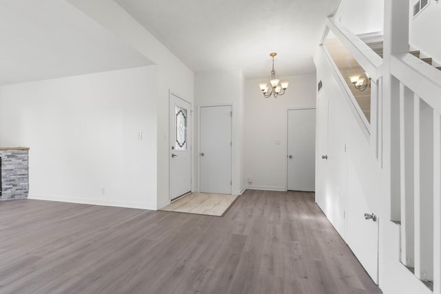 entrance foyer featuring light hardwood / wood-style floors and a notable chandelier