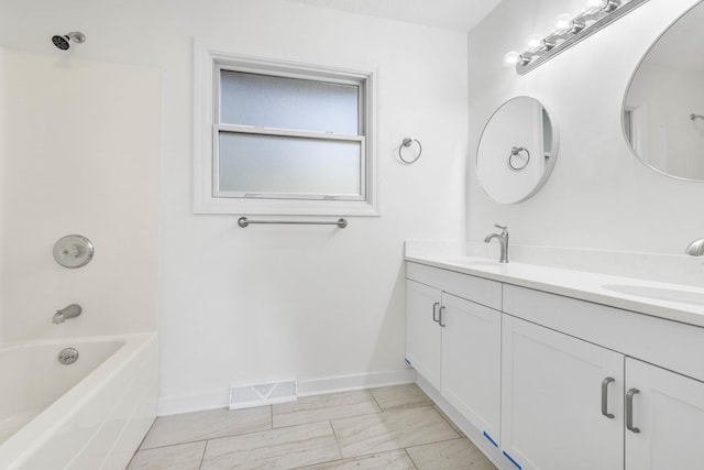 bathroom featuring shower / washtub combination, vanity, and tile patterned flooring