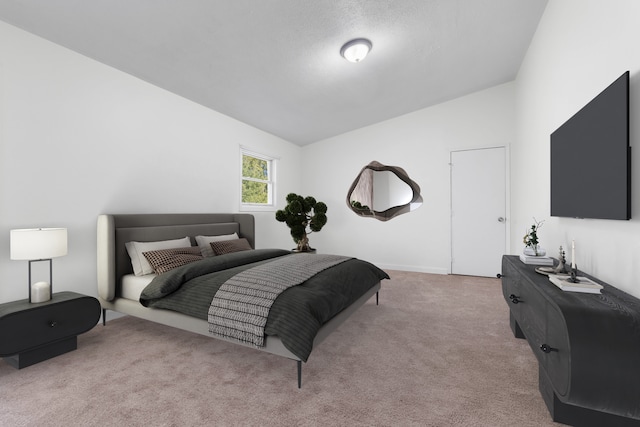 bedroom featuring light carpet and lofted ceiling