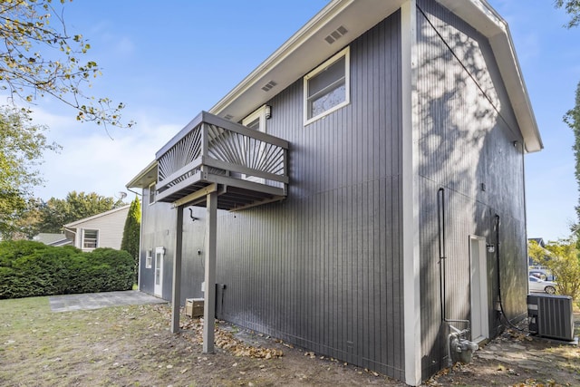 view of property exterior with a balcony and central air condition unit