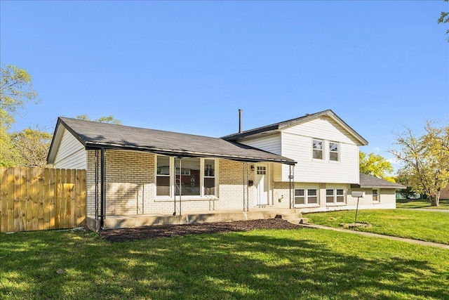 tri-level home with a front yard