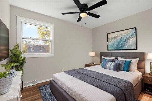 bedroom with ceiling fan and dark hardwood / wood-style floors