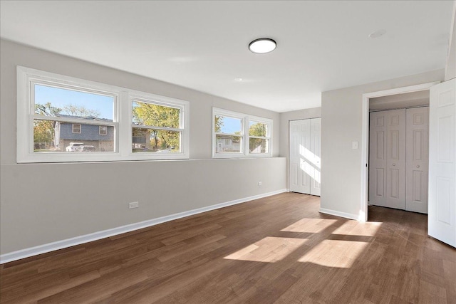 unfurnished bedroom with dark hardwood / wood-style floors