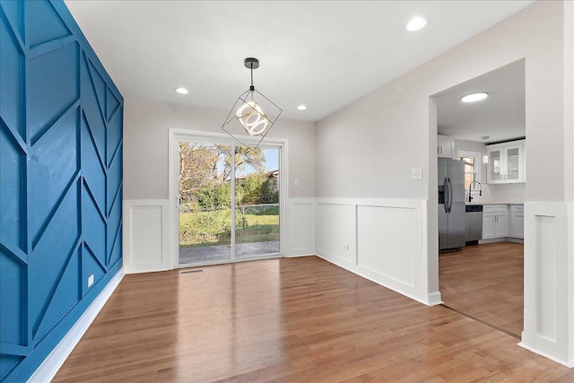 unfurnished dining area with light hardwood / wood-style floors and sink