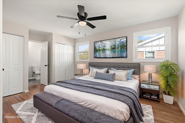 bedroom with hardwood / wood-style flooring, multiple windows, and ceiling fan