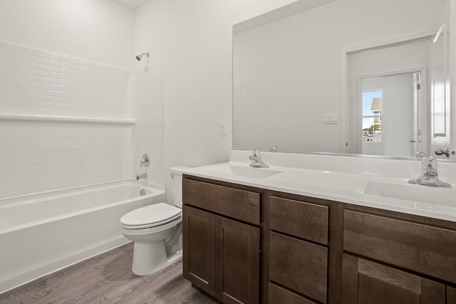 full bathroom featuring hardwood / wood-style flooring, vanity, toilet, and tub / shower combination