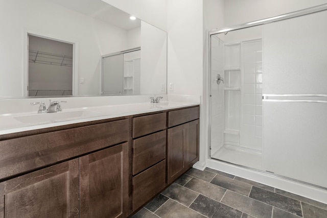 bathroom featuring vanity and a shower with door