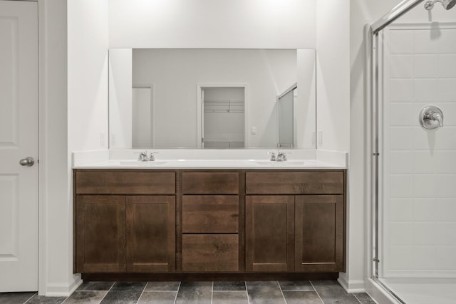 bathroom with vanity and a shower with shower door