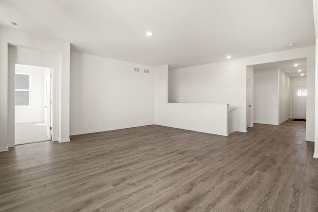 spare room with dark wood-type flooring