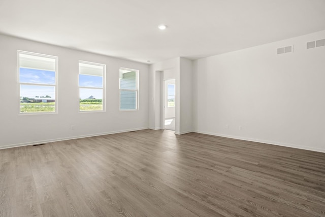 spare room with wood-type flooring