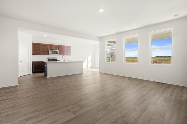 unfurnished living room featuring dark hardwood / wood-style flooring