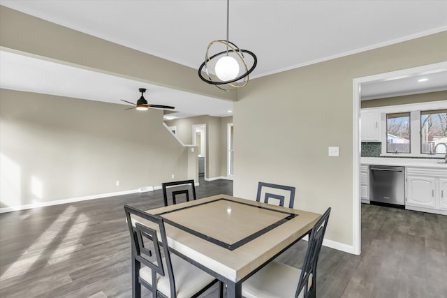 dining area with dark hardwood / wood-style floors, ceiling fan, crown molding, and sink