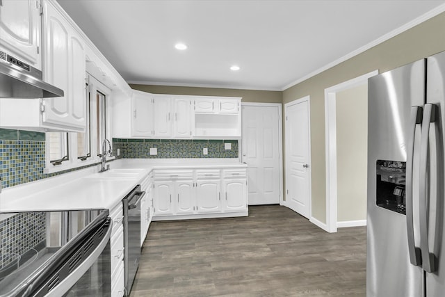 kitchen featuring sink, dark wood-type flooring, stainless steel appliances, crown molding, and white cabinets